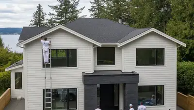 Professional house painters working on exterior home repaint in Redmond WA